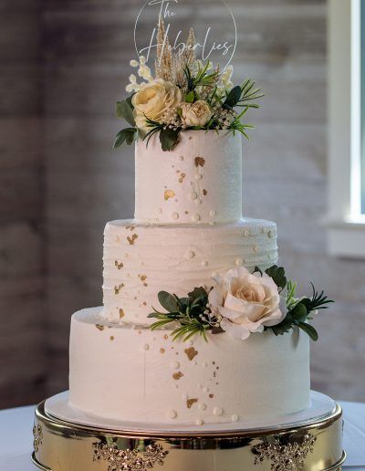 Elegant Buttercream Wedding Cake with Gold Foil Accents